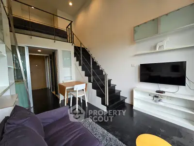 Modern loft apartment with sleek staircase and cozy living area