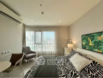 Spacious bedroom with modern decor and large window offering natural light.