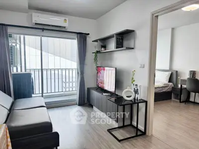 Modern living room with balcony access and sleek furniture in a stylish apartment.