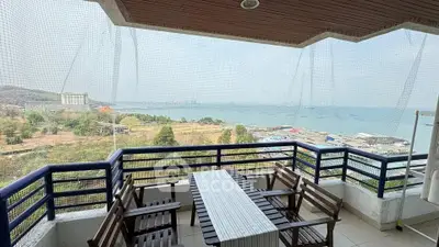 Stunning balcony with panoramic sea view and outdoor dining area