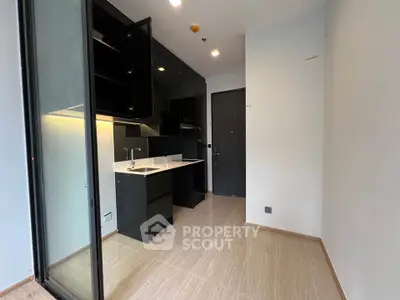 Modern kitchen with sleek black cabinets and open layout