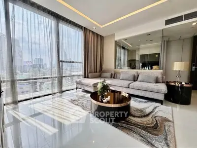 Luxurious modern living room with panoramic city views and elegant furnishings.