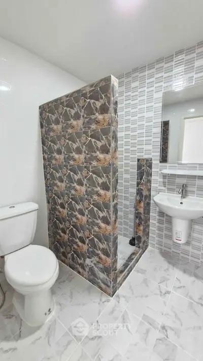 Modern bathroom with stylish tile design and compact layout