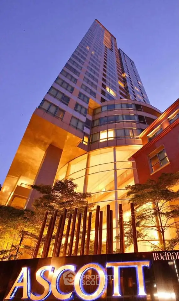 Stunning view of a modern high-rise building at dusk with illuminated signage.