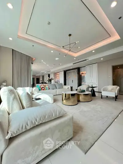 Luxurious modern living room with elegant decor and spacious seating area.