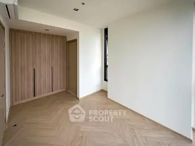 Spacious empty room with wooden flooring and built-in wardrobe, perfect for customization.