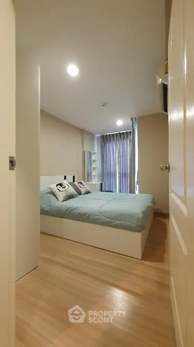 Modern bedroom with cozy bed and stylish decor in a contemporary apartment.