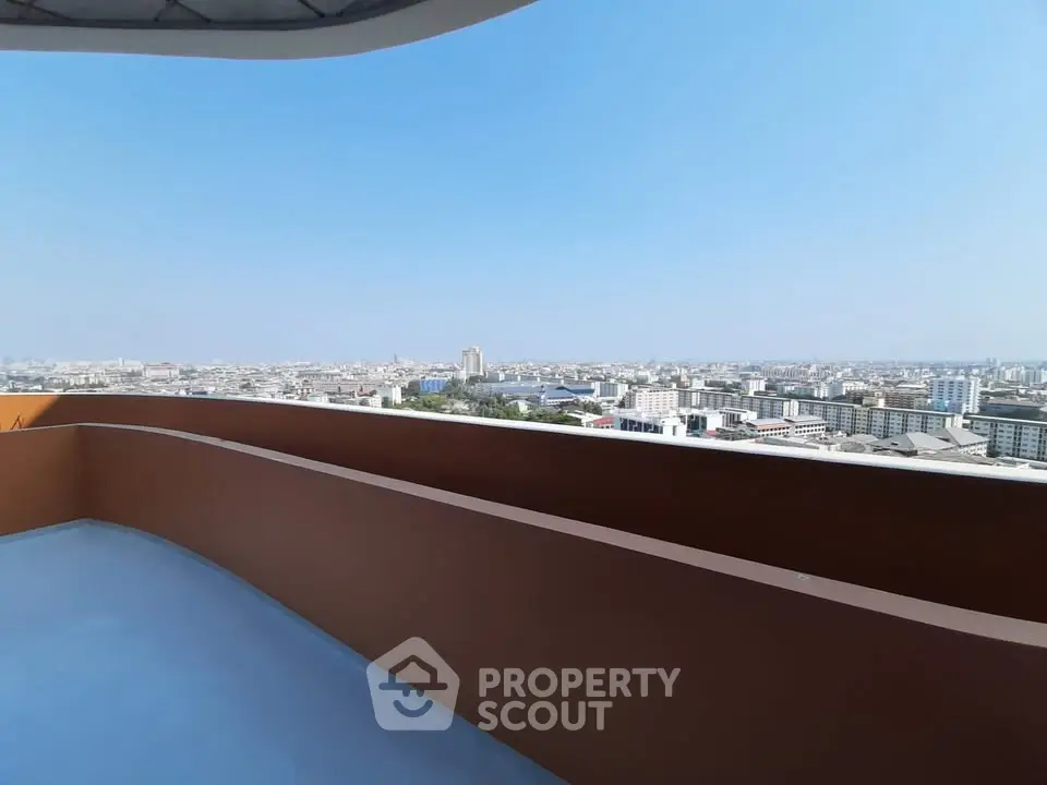 Stunning cityscape view from a spacious balcony in a modern high-rise apartment.