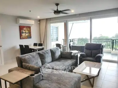 Spacious living room with modern furniture and balcony view