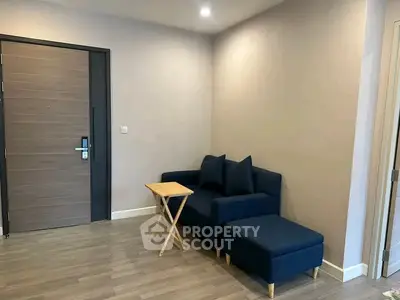 Modern living room with sleek blue sofa and wooden side table, perfect for cozy relaxation.
