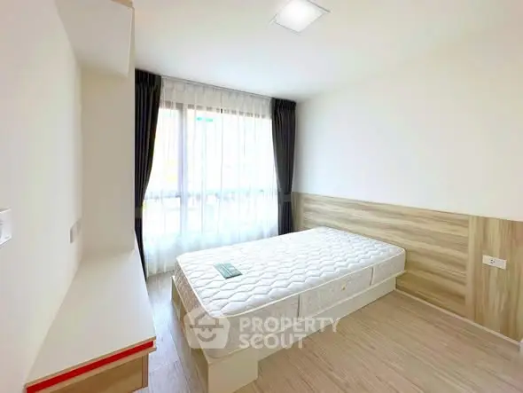 Bright minimalist bedroom with large window and modern decor