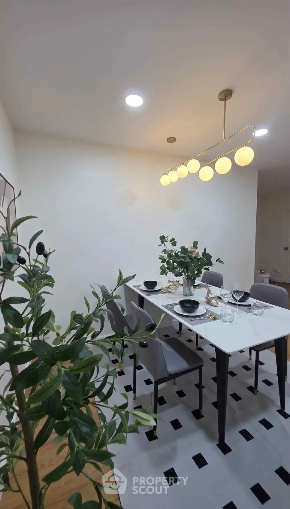 Elegant dining area with modern lighting and stylish decor, perfect for entertaining guests.