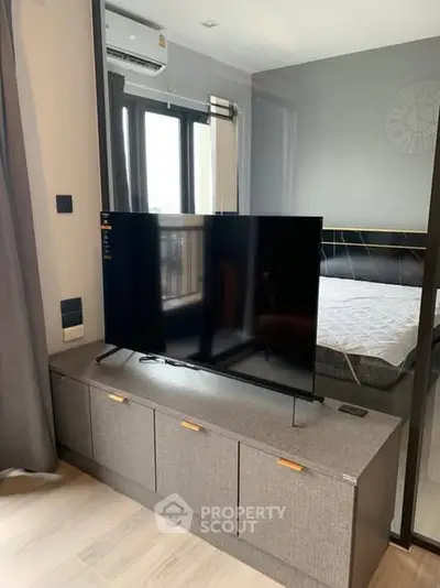 Modern bedroom with sleek TV setup and stylish decor