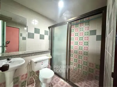 Charming bathroom with vintage tile design and modern shower enclosure