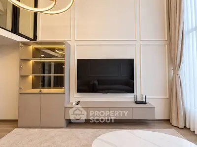 Modern living room with sleek TV setup and elegant lighting
