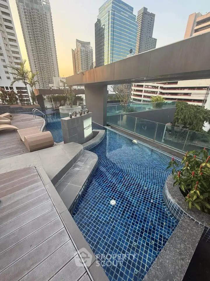 Luxurious rooftop pool with stunning city skyline views in modern high-rise building.