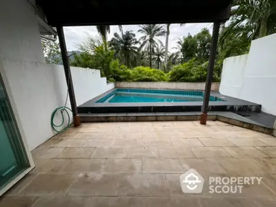 Stunning private pool area with lush greenery and spacious patio, perfect for relaxation and entertainment.