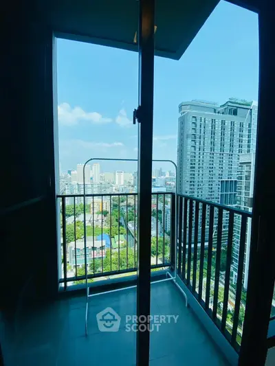 Stunning high-rise balcony view with cityscape and blue sky, perfect for urban living.