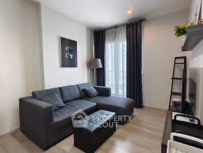 Modern living room with sleek furniture and large window view