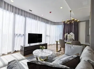 Luxurious modern living room with elegant decor and abundant natural light.