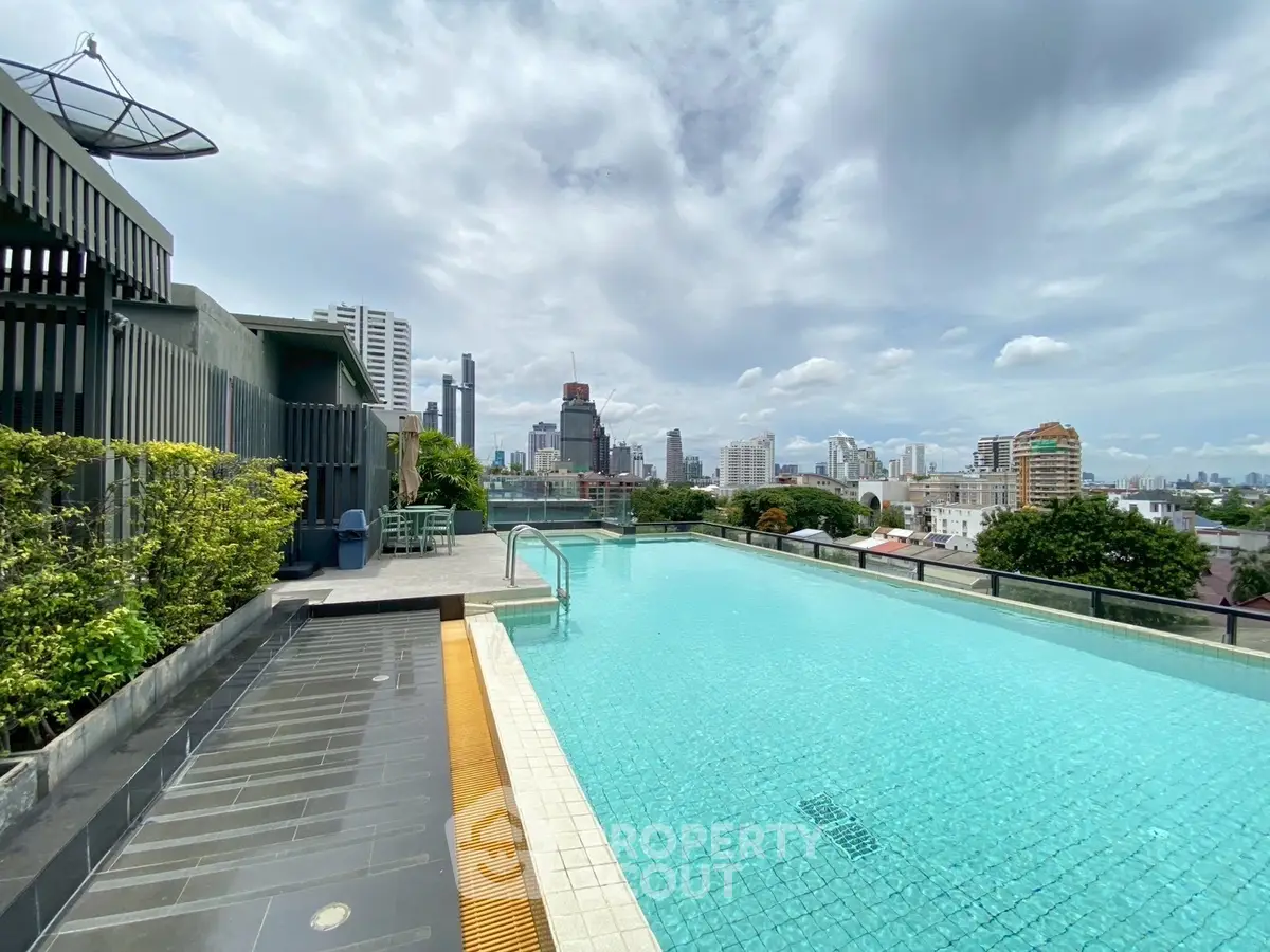 Stunning rooftop pool with panoramic city views, perfect for relaxation and leisure in a modern urban setting.