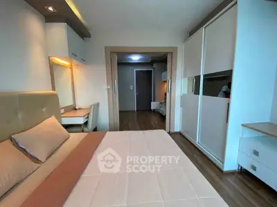 Modern bedroom with stylish furniture and ample storage in a contemporary apartment.