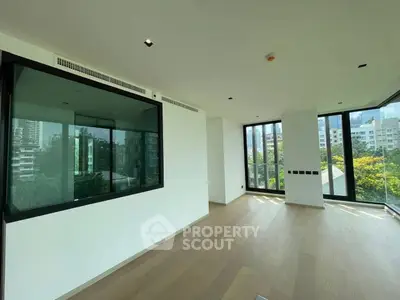 Spacious modern living room with large windows and city view