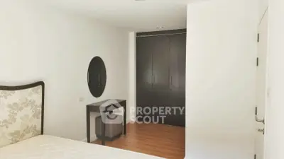 Spacious bedroom with elegant decor and ample storage space