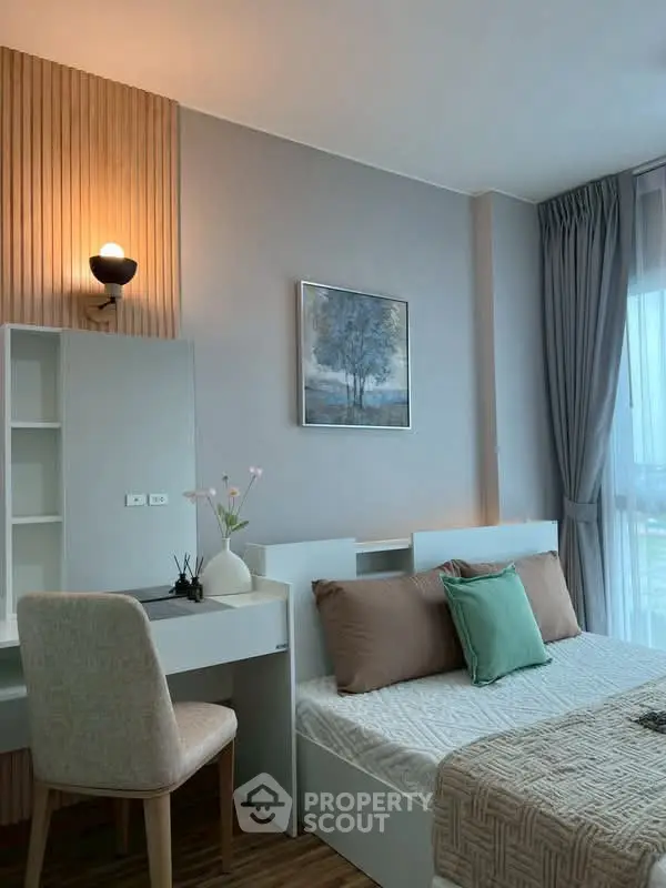 Modern bedroom with stylish decor and natural light, featuring a cozy bed and elegant furniture.