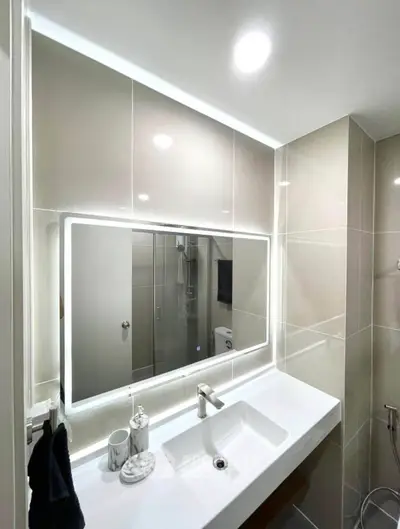 Modern bathroom with illuminated mirror and sleek fixtures