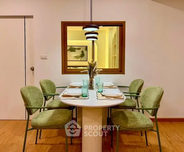 Stylish dining area with modern decor and elegant lighting in a cozy apartment setting.