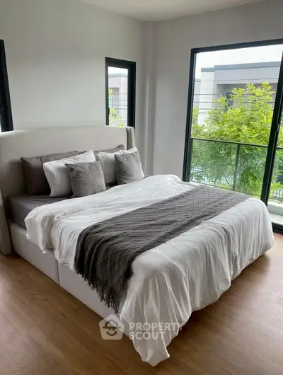 Modern bedroom with large windows and stylish decor
