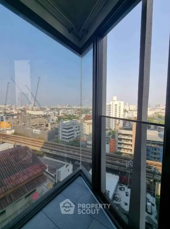 Stunning urban view from high-rise corner unit with floor-to-ceiling windows.