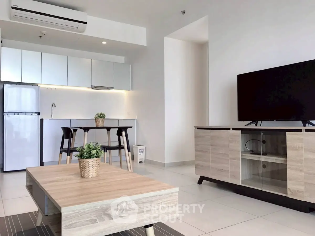 Modern open-plan living room with sleek kitchen and stylish furniture