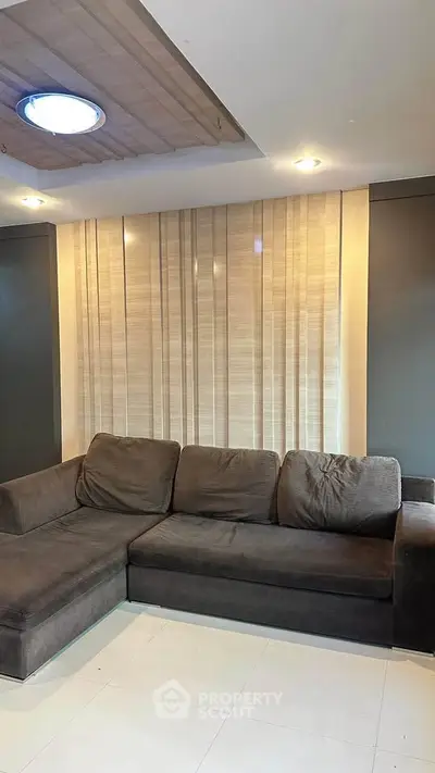 Modern living room with stylish sectional sofa and elegant lighting