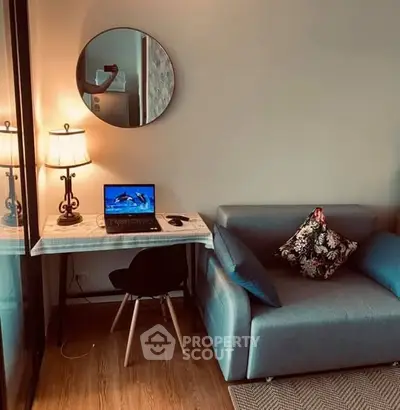 Cozy study nook with modern decor and comfortable seating in stylish apartment.