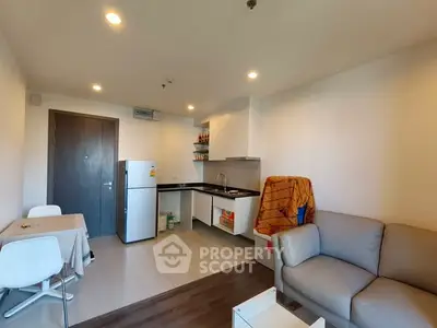 Modern apartment interior with cozy living area and compact kitchen.