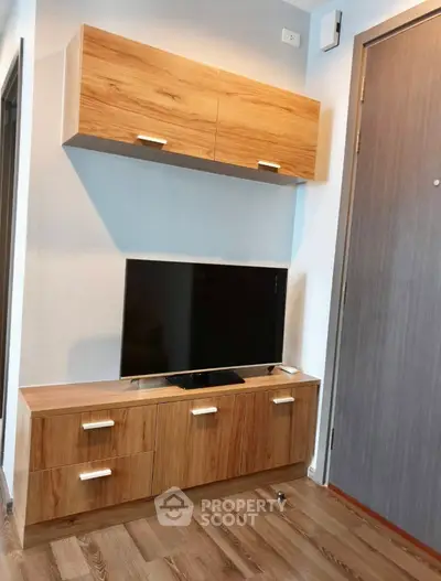 Modern living room with stylish wooden TV cabinet and mounted storage, perfect for contemporary homes.
