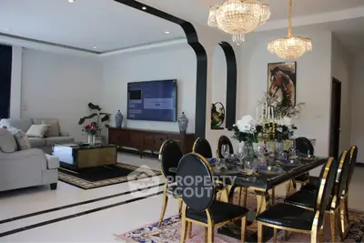 Luxurious living and dining area with elegant chandeliers and modern decor