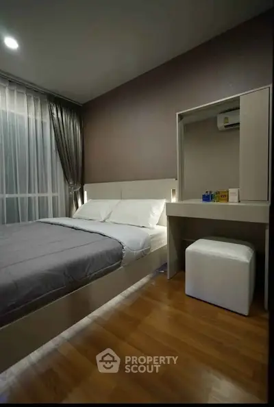 Modern bedroom with sleek design, featuring a cozy bed and stylish furniture, perfect for urban living.
