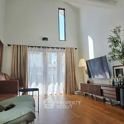 Spacious living room with high ceiling and modern decor