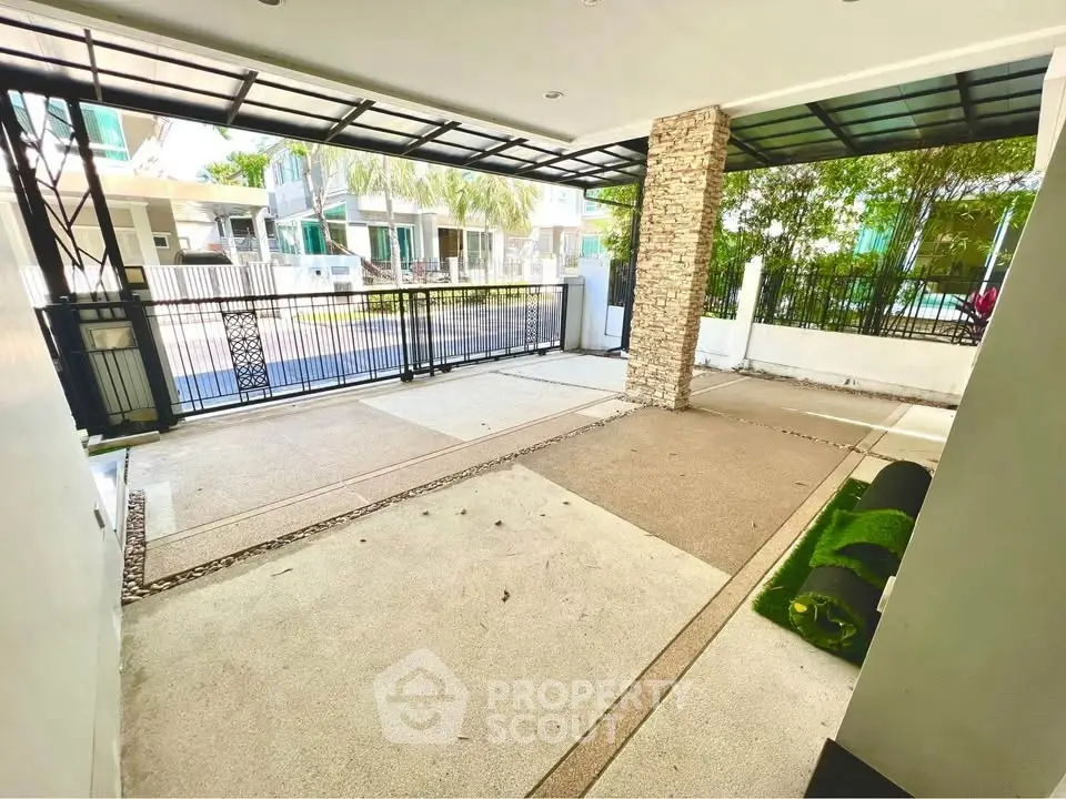 Spacious modern carport with sleek design and gated entrance in a residential area.