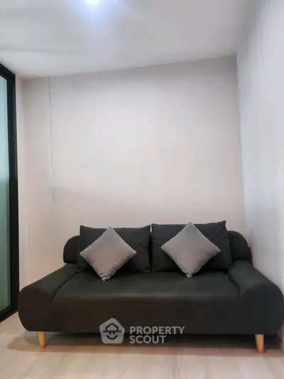 Modern living room with sleek black sofa and minimalist decor