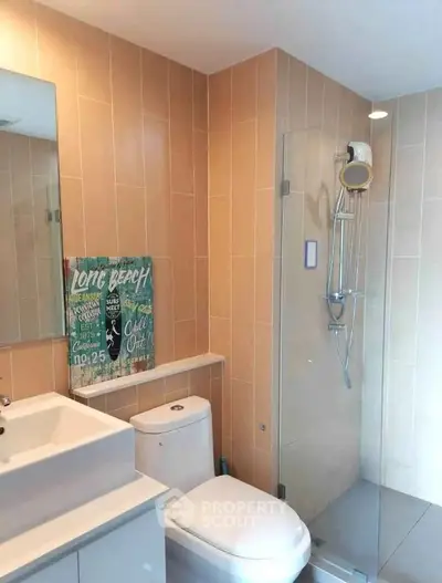 Modern bathroom with glass shower and sleek fixtures in a stylish apartment.