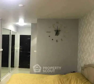 Cozy bedroom with modern decor and large mirrored wardrobe