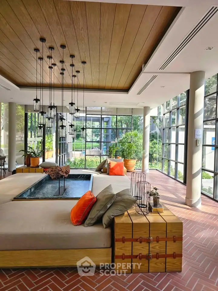 Luxurious living room with modern design and large windows offering garden view