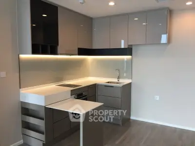Modern kitchen with sleek cabinetry and integrated appliances in a contemporary apartment.