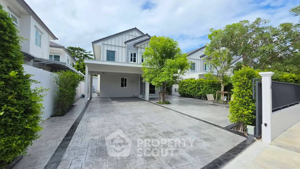 Stunning modern house with spacious driveway and lush greenery, perfect for family living.