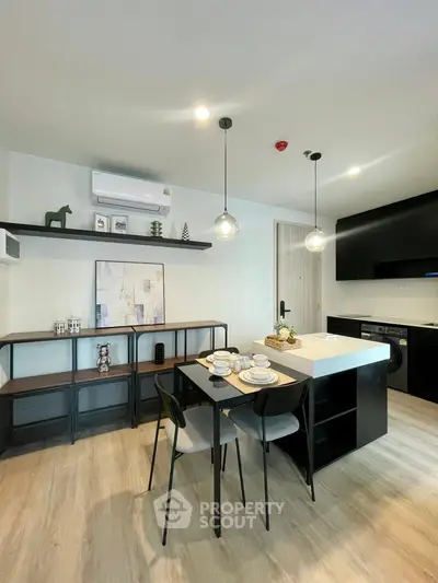 Modern kitchen with sleek black cabinetry and stylish dining area