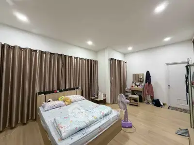 Spacious bedroom with modern decor and ample natural light